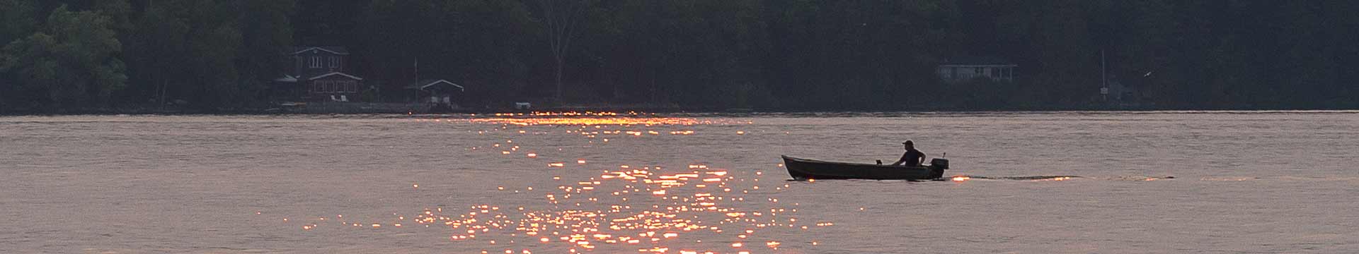 Fisherman out in his boat at sunset. Photo credit: John MacLean